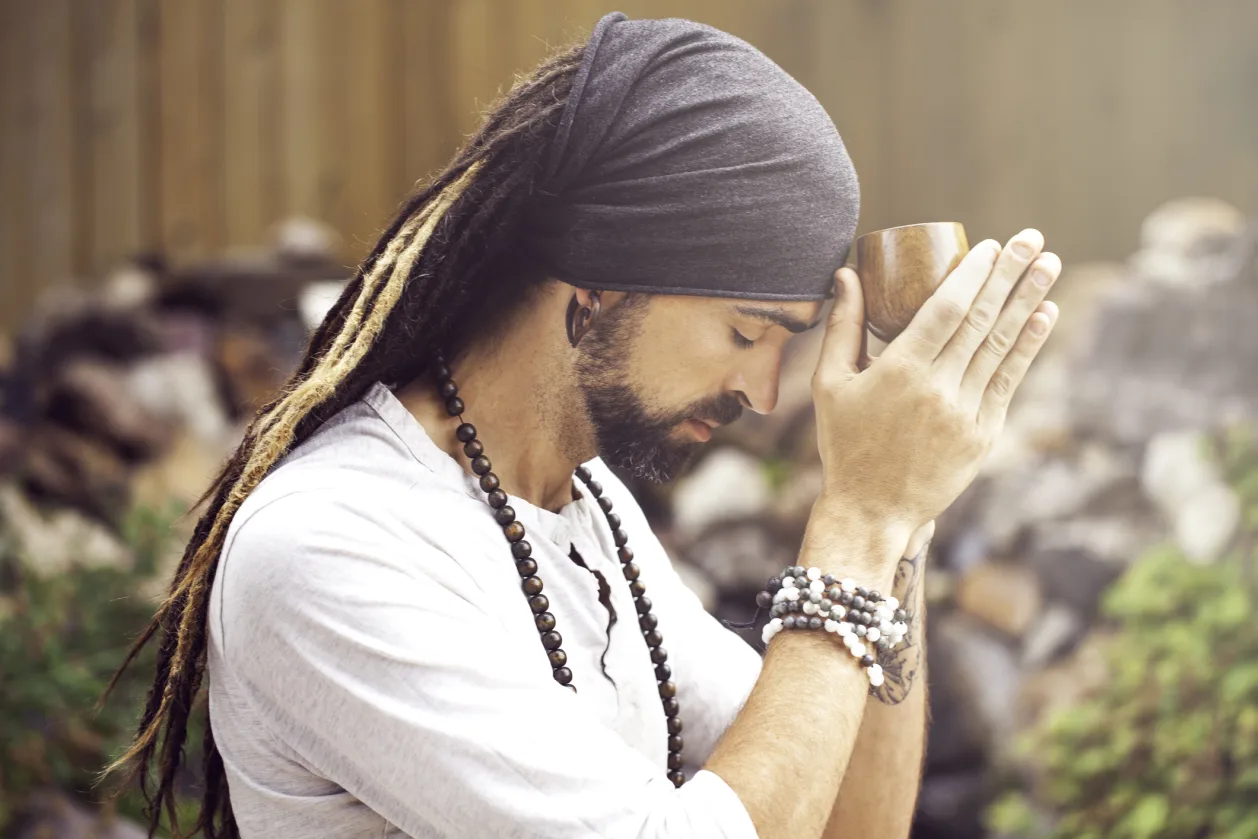 Man Holding Ceremonial Ayahuasca Drink to His Third Eye